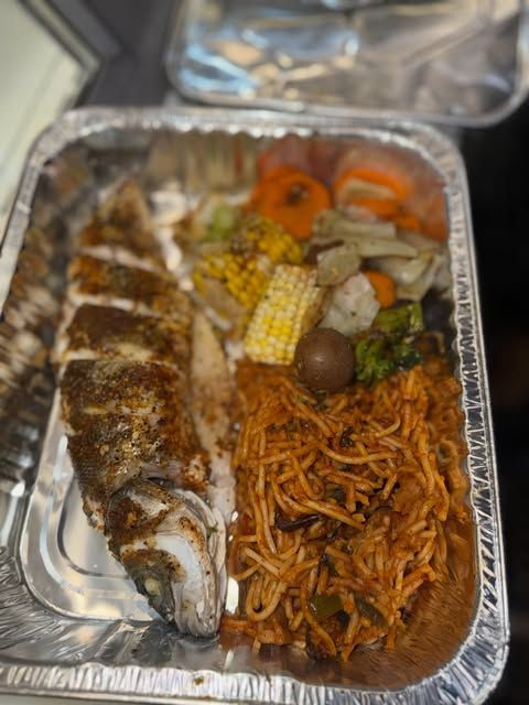 Whole seasoned fish with spaghetti, corn and vegetables